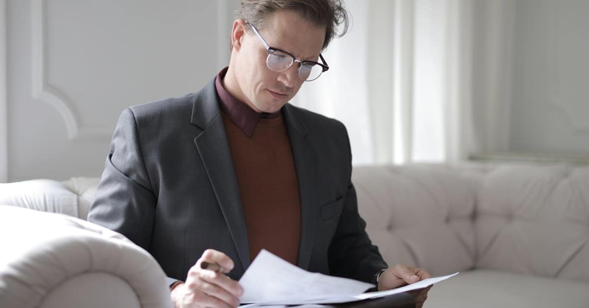 man reading over contractual alimony agreement in divorce settlement texas