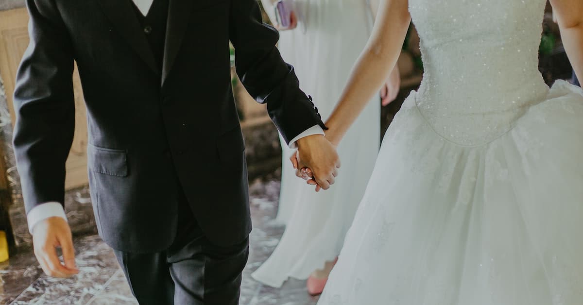 couple at wedding in texas holding hands