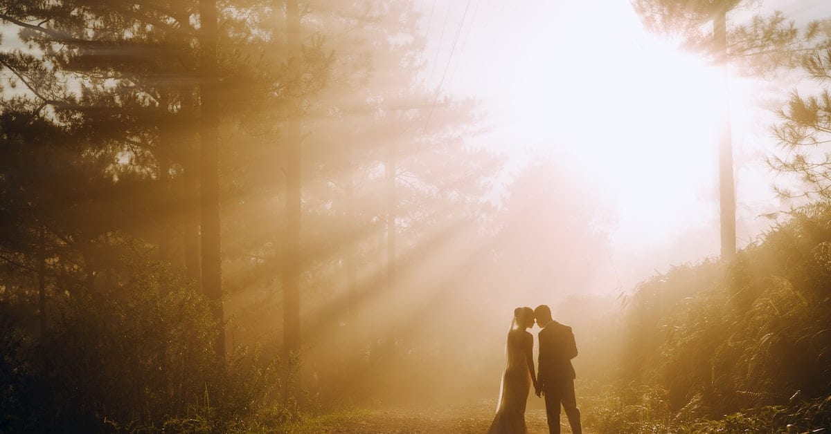 man and woman getting remarried in texas in woods with beautiful light