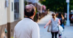 man watching wife walk down street trying to get cheap divorce in texas