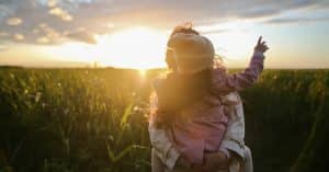 parent holding child outside at sunset after texas divorce custody battle