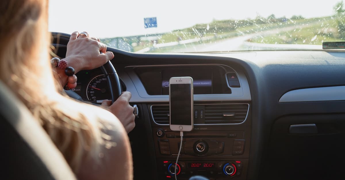 person driving car with iphone mount awarded car in texas divorce