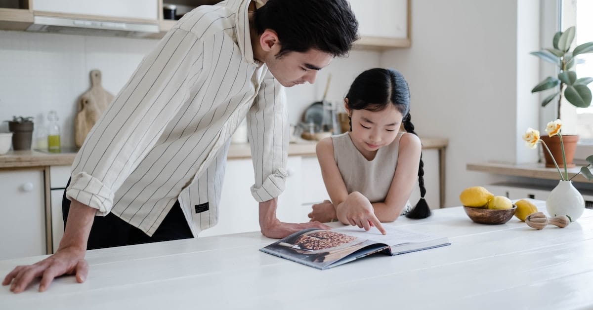 father looking at book with daughter after texas divorce