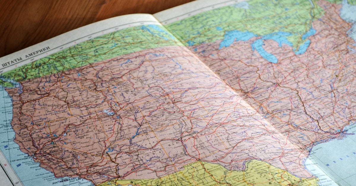 map book open to page of us by person thinking about filing for divorce in different state than texas