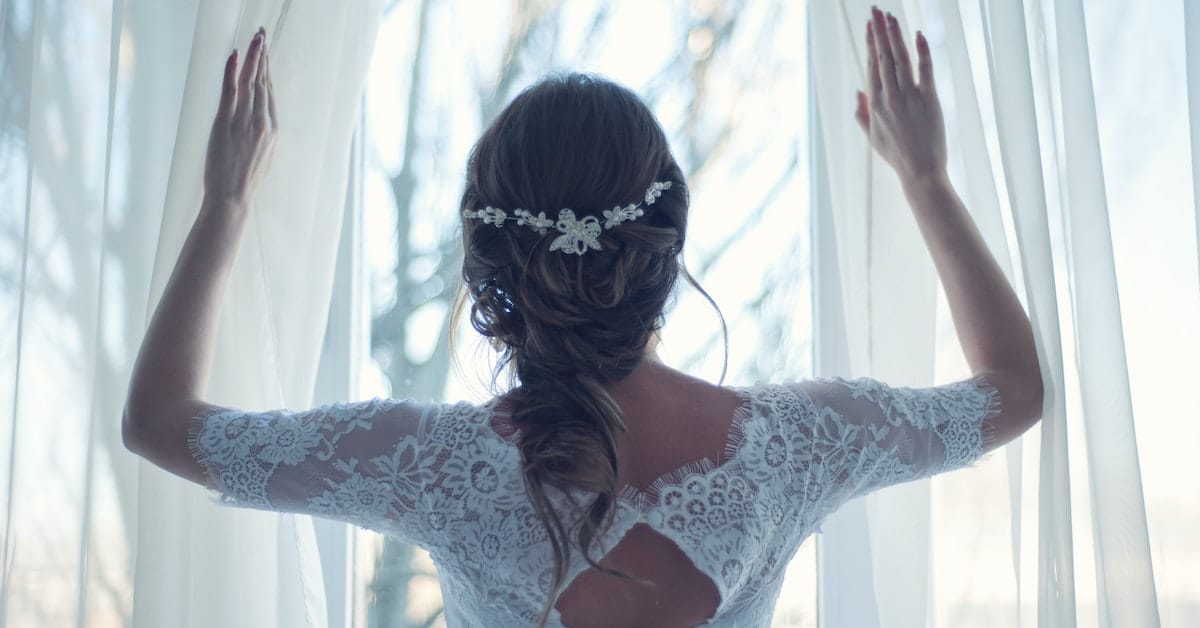 woman looking out window in wedding dress wondering when she can get remarried in texas after divorce