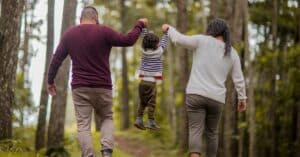 divorcing husband and wife walking with child they are agreeing to no child support for