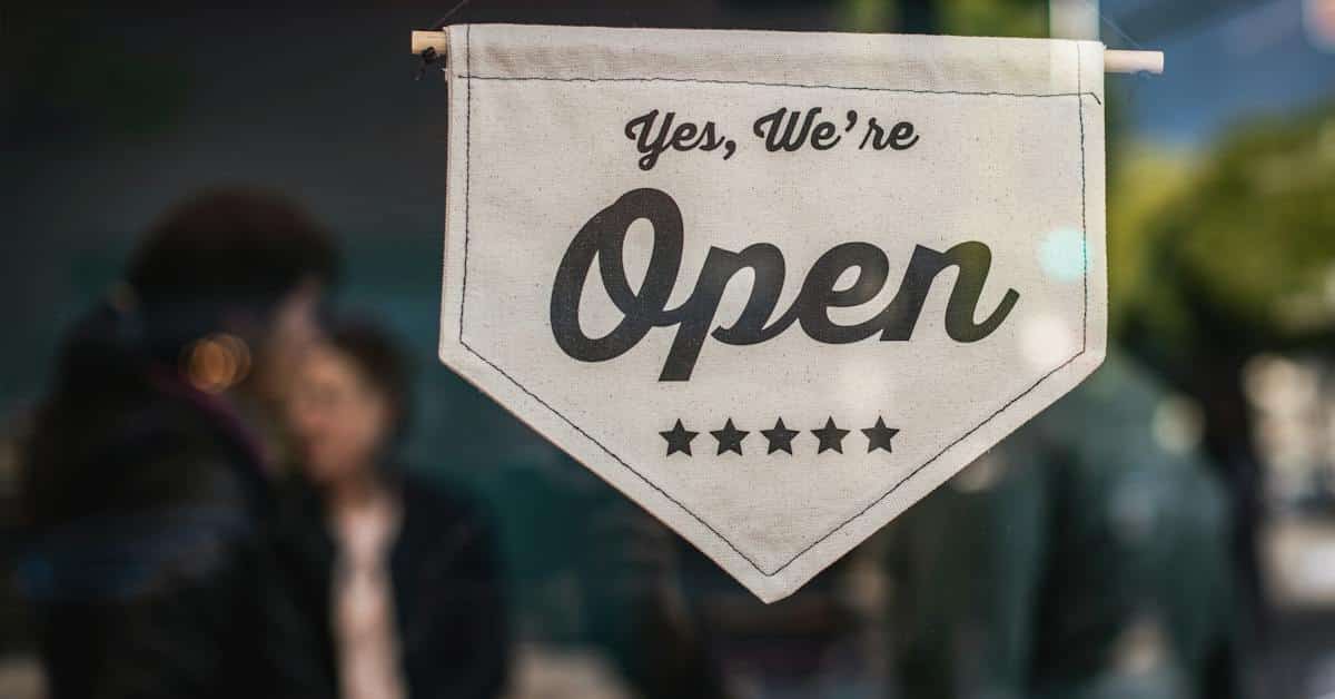small business open sign owned by couple getting postmarital agreement in texas
