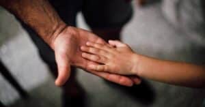 hands of father and son applying for child support in texas