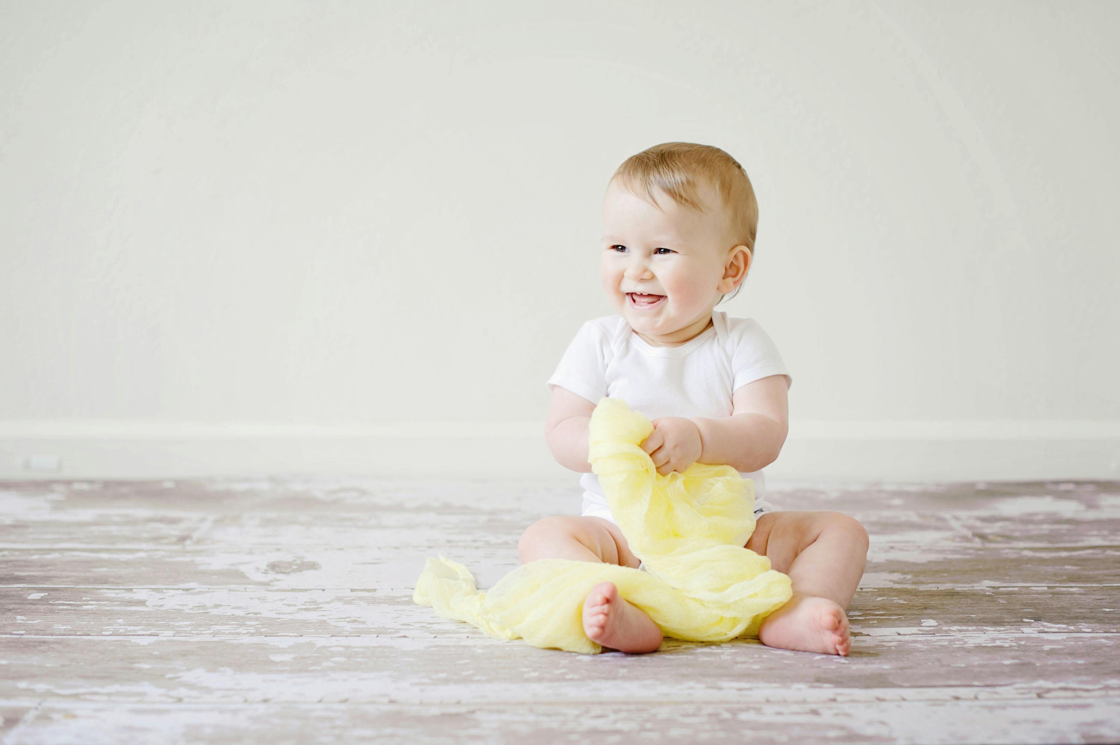 how to get fully custody of a child baby siting on floor smiling